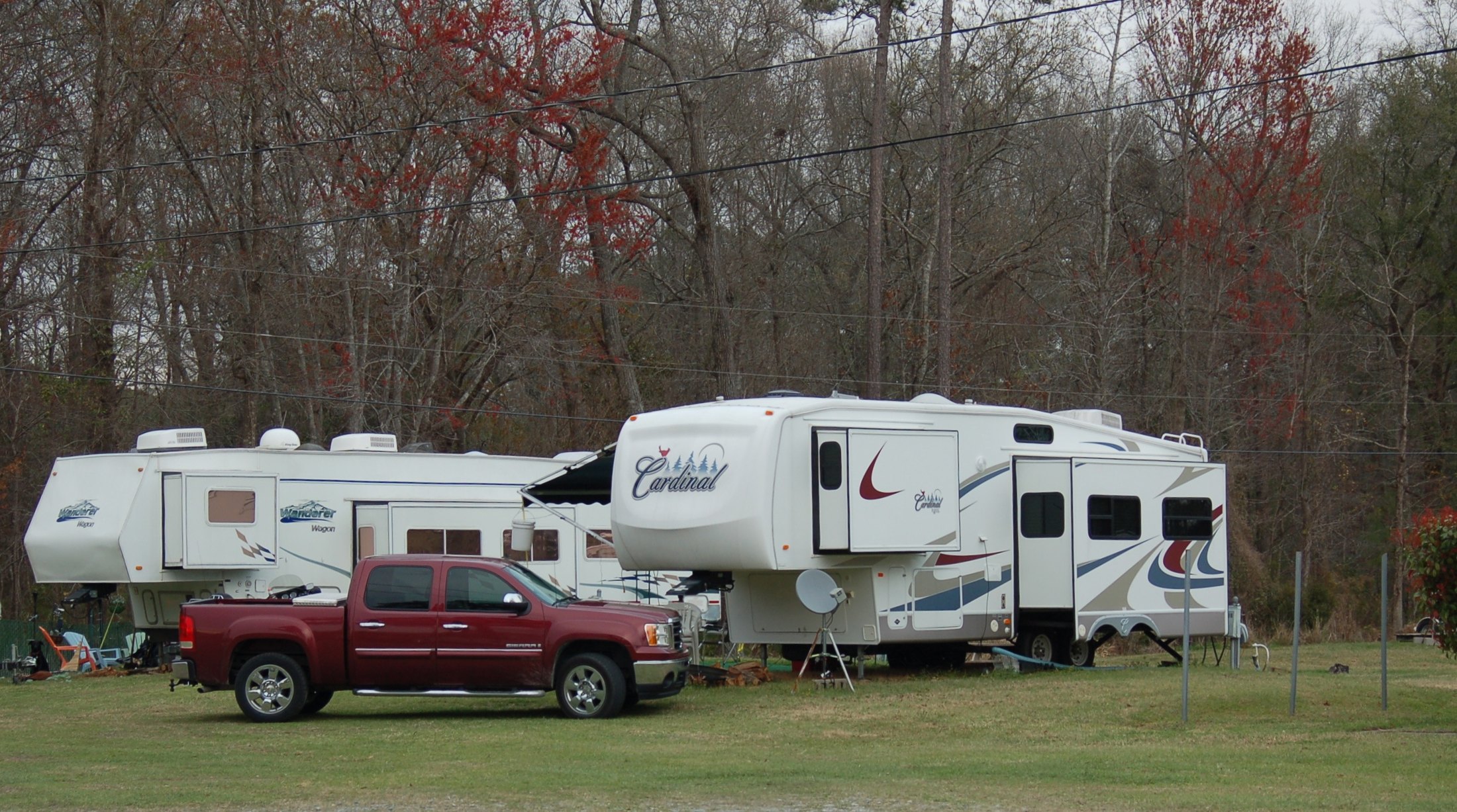 Motorcoach and passenger vehicle at an RV site