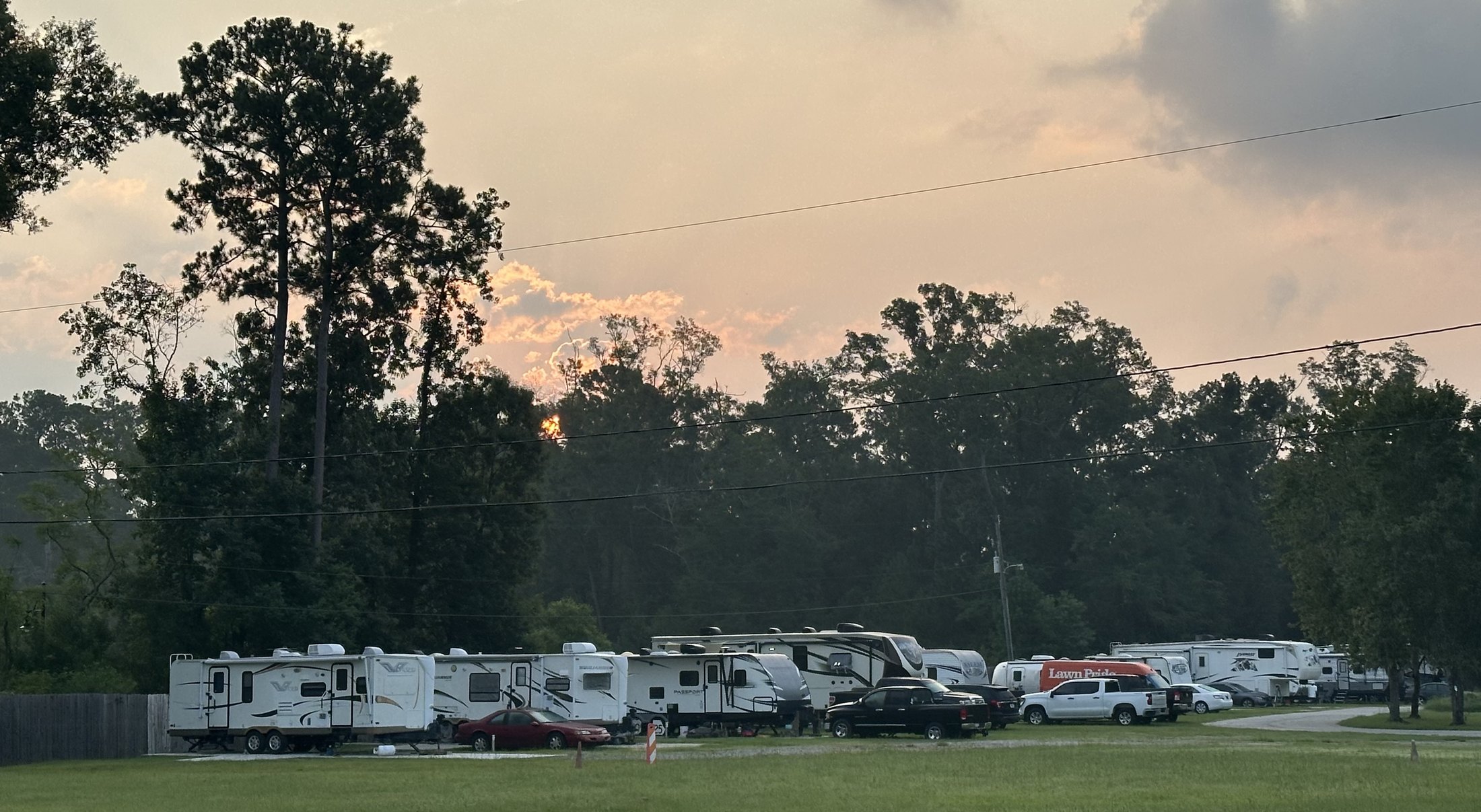 Open lawn with RV sites beyond at sunrise